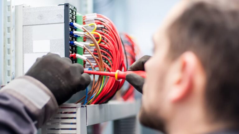 Electrician working on electric wires — John McEwan Electrical in Wollongong, NSW