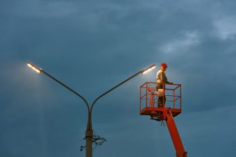 Electrician fixing street light — John McEwan Electrical in Wollongong, NSW